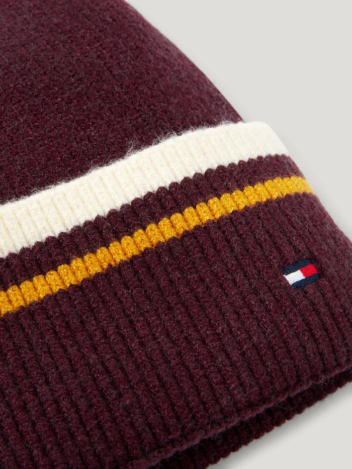 Closeup view of Tommy Hilfiger Dean Pom-Pom Beanie in burgundy