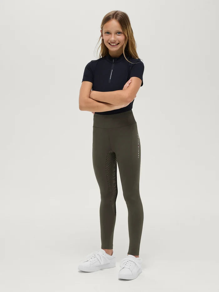 Young girl wearing Tommy Hilfiger Kids' Devon Riding Leggings in Camo Green